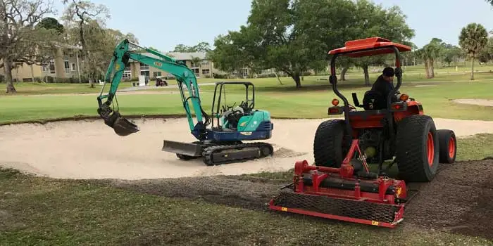 Westscapes Golf Construction founder with excavator on golf course.